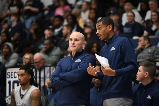 Aaron Thompson talks with Chris Caputo on the sideline during a game