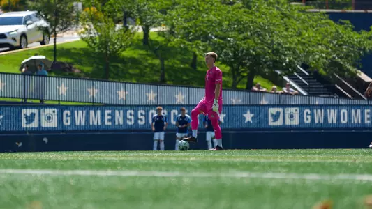 Tom Macauley standing over the ball at the GW Soccer Field