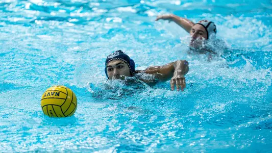 Water polo swimming to ball at Navy