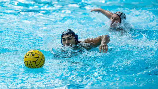 Water polo swimming to ball at Navy