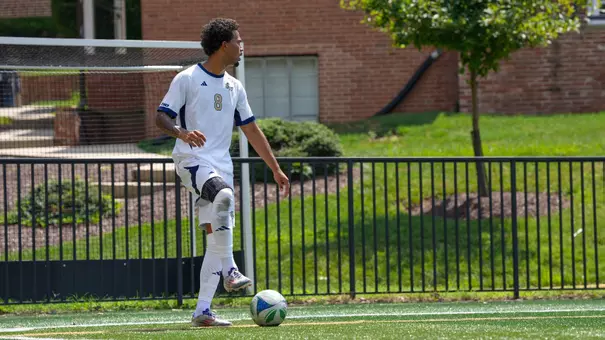 Jaden Dubon standing over the ball at the GW Soccer Field