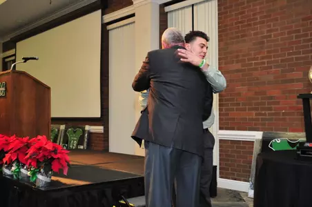 Justin Haig hugs Doc Holliday at last week's team banquet.