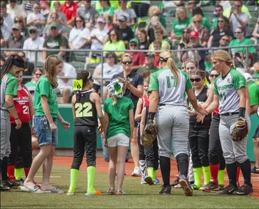 Rebecca Myslenski leading her Lil' Sis's out on the field. Photo Credit David Myslenski