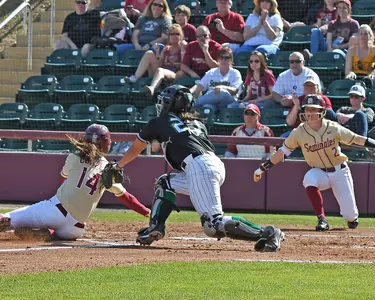 Junior Taylor McCord applies the tag at home after the throw from center by sophomore Abigail Estrada.