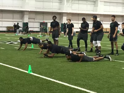 Marshall players participate in one of six stations during morning mat drills.