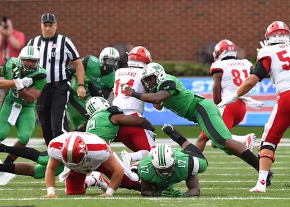 Marquis Couch gets help tackling a Miami player in Marshall's 31-26 win against the RedHawks on Sept. 2, 2017.