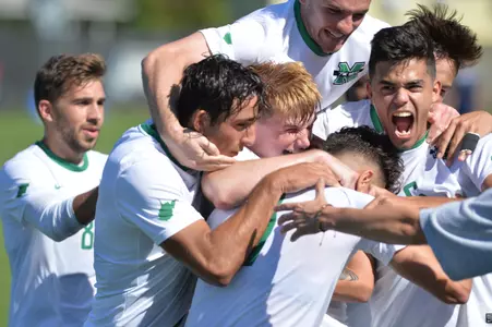 Freshman Lewis Knight (center) celebrates with his teammates after scoring against No. 21 Kentucky at home. The Herd won the game 1-0.