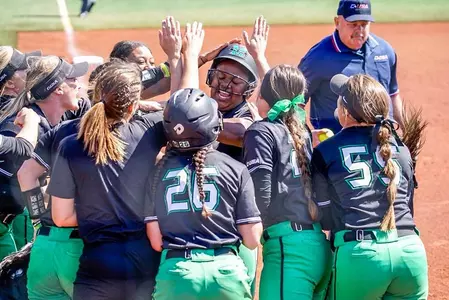 The Herd celebrates at home plate in the second inning following Aly Harrell's home run.