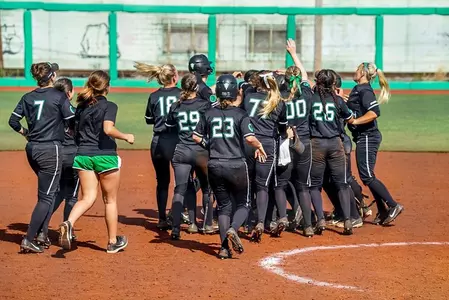 Marshall celebrates and mobs Rachel Rousseau after her walk-off double in game two.