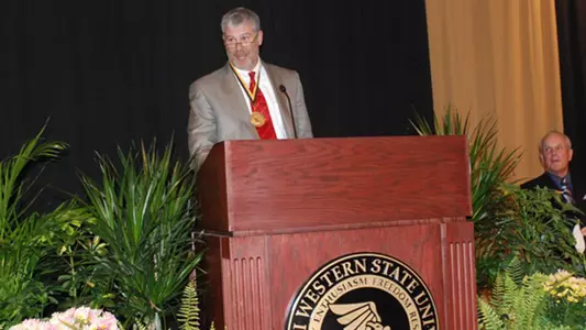 Rhoads Accepts Alumni Honor