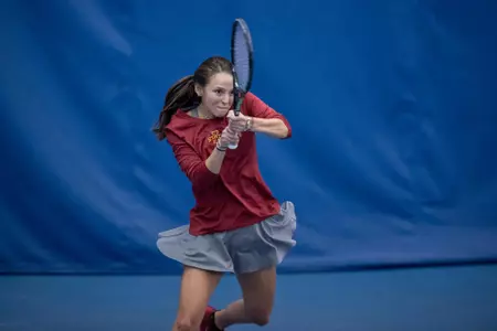 Regina Espindola returns the tennis ball.