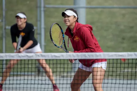 Maty Cancini and Regina Espindola await the serve from their opponent.