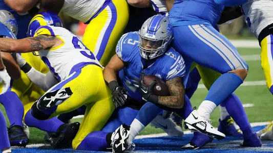 Detroit Lions running back David Montgomery (5) rushes for a 1-yard touchdown during the first half of an NFL wild-card playoff football game, Sunday, Jan. 14, 2024, in Detroit. (AP Photo/Duane Burleson)