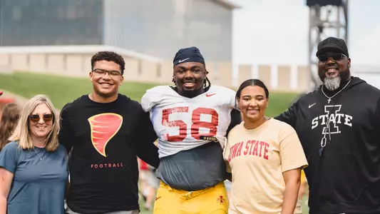 J.R. Singleton with the Bray family and Coach Eli Rasheed