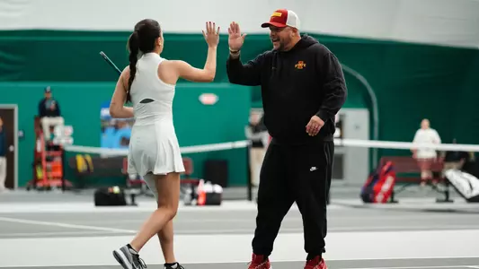 Head coach Jaron Maestas celebrates with Mari Paz Alberto Vilar after a point against Omaha.