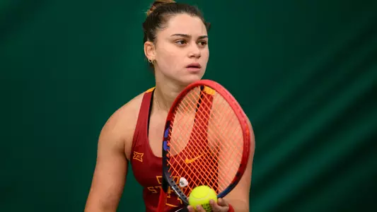 Gabriela Felix prepares to serve against North Texas.