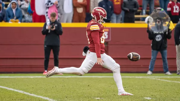 Iowa State punter Tyler Perkins kicks a ball.