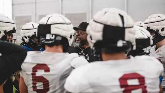 Eli Rasheed talks to players after spring practice