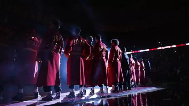 Iowa State Wrestlers stand in Hilton Coliseum wearing the iconic Iowa State wrestling robes.