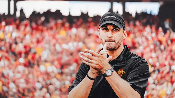 Quarterback coach Keith Heckendorf claps.