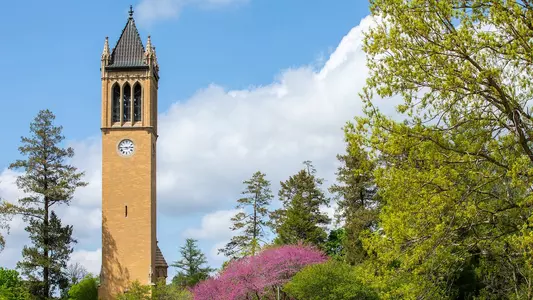 The campanile on Iowa State's campus with spring foliage