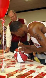 Senior Lewis Monroe meets donors after basketball practice.