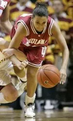 Minnesota guard April Calhoun, left, and Indiana guard Annika Boyd, right, get tangled up as they battle for a loose ball during the first half of a college basketball game in Minneapolis, Thursday, Feb. 23, 2006. (AP Photo/Ann Heisenfelt)