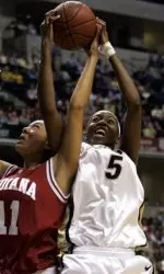 Purdue's Aya Traore, right, and Indiana's Whitney Thomas battle for a rebound during the first half of a semi-final basketball game in the Big Ten Conference tournament in Indianapolis, Sunday, March 5, 2006. (AP Photo/Michael Conroy)