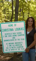 Christina Loukas seen with one of her signs in Riverwoods, Ill.