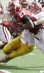 Bryan Payton goes in for a one-yard touchdown run while being tackled by Minnesota linebacker John Shevlin during the second quarter. (AP Photo/Darron Cummings)