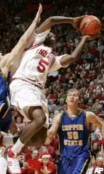 Jordan Crawford is fouled by Coppin State forward Brian Chesnut as he puts up a shot during the first half. (AP Photo/Darron Cummings)