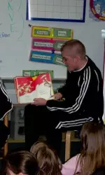 Sophomore Chay Cain reads to a group of local students.