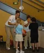 Hoosier guards Leah Enterline (left) and Nikki Smith (right) help a pair of young fans get ready for a ball dribbling activity on Saturday, April 28, at WonderLab.