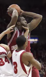Indiana's D.J. White grabs an offensive rebound against Wisconsin's Greg Stiemsma (34) and Trevon Hughes during the first half. (AP Photo/Andy Manis)