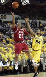 Indiana guard Eric Gordon (23) throws up a shot with Michigan forward Ron Coleman (24) in pursuit, in the first half (AP Photo)