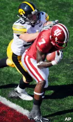 Ray Fisher catches a touchdown pass as Iowa's Brent Greenwood defends during the final minute of the second quarter. (AP Photo/The Herald-Times, Chris Howell)