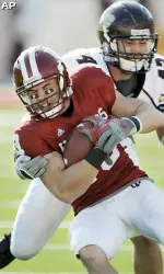 Andrew Means tries to fight off Central Michigan's Nick Bellore in IU's 37-34 loss. (AP Photo/Bloomington Herald-Times, Chris Howell)