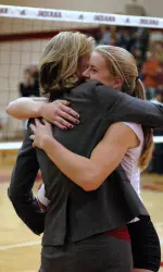 Ashley Benson gets a hug from Head Coach Sherry Dunbar after being presented a gift for breaking the IU single-season blocks record