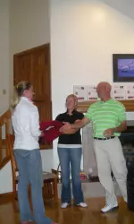 Freshman Lauren Giesecke is awarded her letterman jacket by head coach Clint Wallman and assistant coach Katie Brophy.