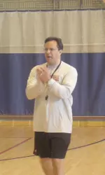 Coach Crean encourages campers inside the HPER Building