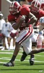Marcus Thigpen goes in for a 12-yard touchdown run against Michigan State linebacker Eric Gordon during the second quarter. (AP Photo/Darron Cummings)