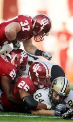 Trea Burgess (21), Justin Carrington (25) and Collin Taylor (37) bring down a Purdue rusher on Nov. 21.