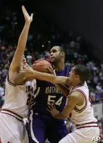 Tom Pritchard and Verdell Jones III defend against Northwestern center Kyle Rowley. (AP Photo/Darron Cummings)