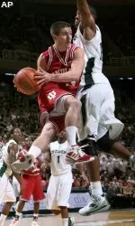 Daniel Moore dishes off against Michigan State's Delvon Roe during the first half.
