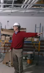 Head coach Bill Lynch shows off the interior of the North End Zone facility.
