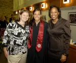 Director of operations Stephanie Siler, senior forward Whitney Thomas and head coach Felisha Legette-Jack at a post-graduation ceremony in Memorial Stadium.