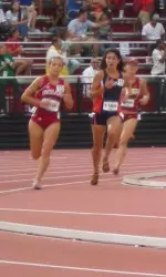 Sophomore Sarah Pease passes two runners on the final lap, on her way to All-America honors.