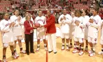 Associate Athletics Director Dr. M. Grace Calhoun presents Whitney Thomas with a game ball.
