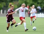 Carly Samp holds off the CMU defender for her first goal of the season.