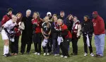 The seniors pose for a picture with their families prior to the start of the game.